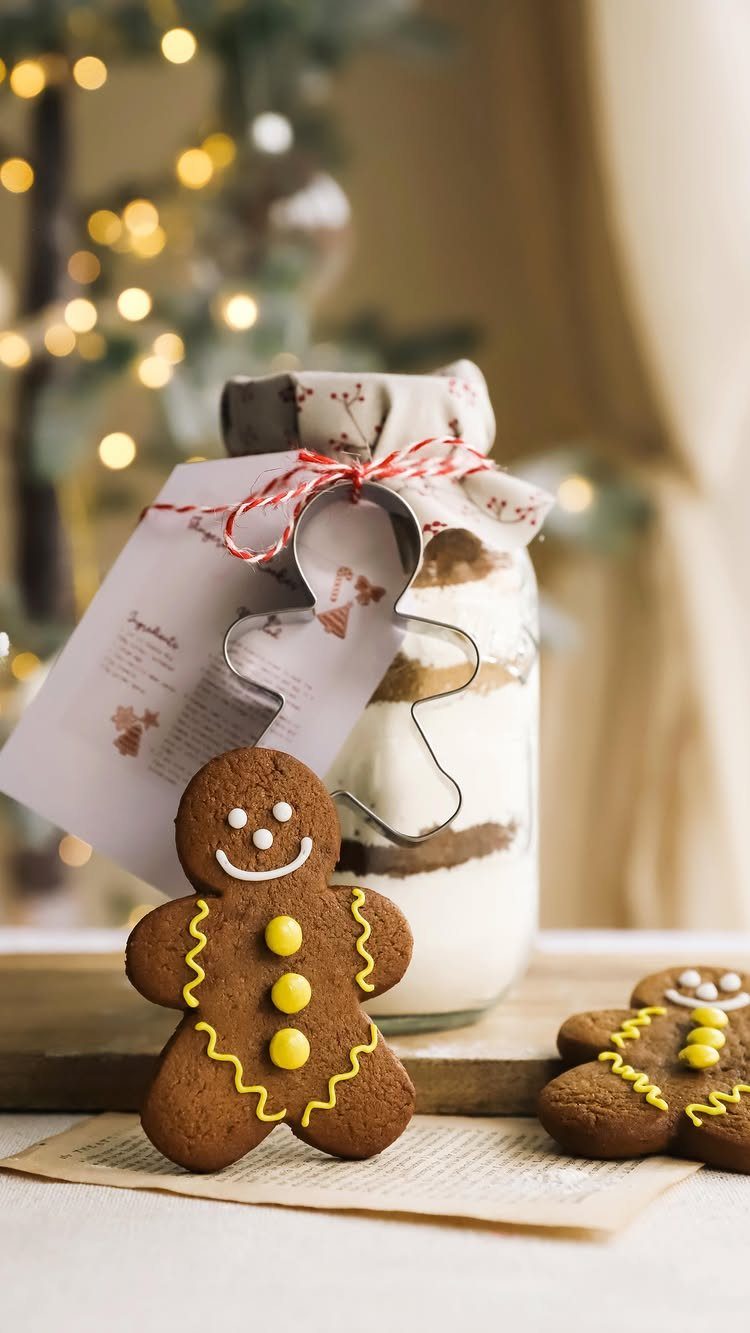 Layered cookie mix in a jar with gingerbread man cookies and a cutter.