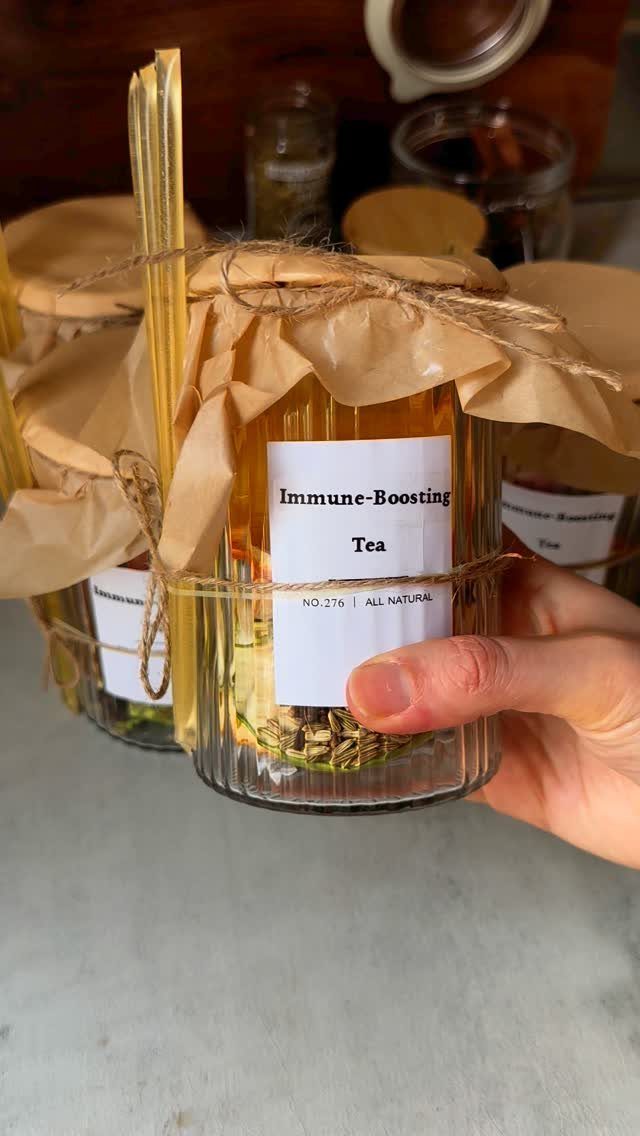 Immune-boosting tea in a glass jar with brown paper lid and twine.
