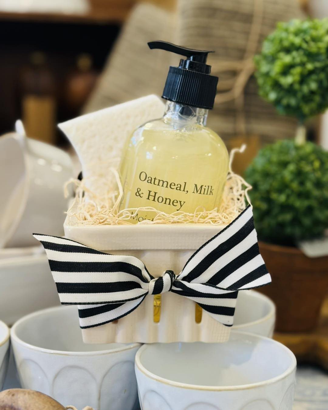5 Housewarming Gift Ideas for Someone Who Has Everything 2 Scented hand soap and sponge in a white crate with a striped bow.