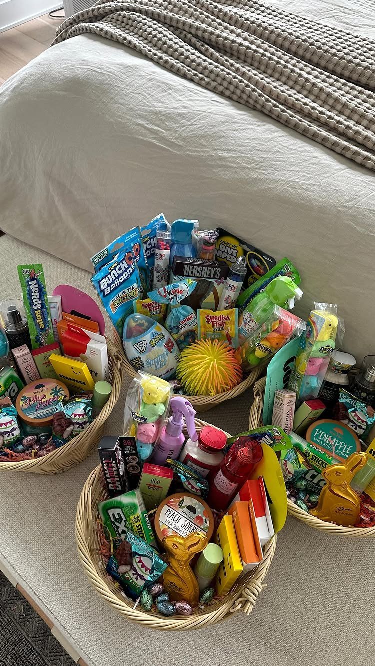 Woven wicker baskets filled with colorful candies and small toys for Easter gifts.