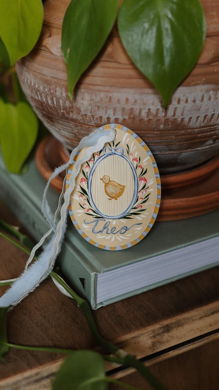 Oval yellow Easter gift tag with a chick illustration and the name Theo.