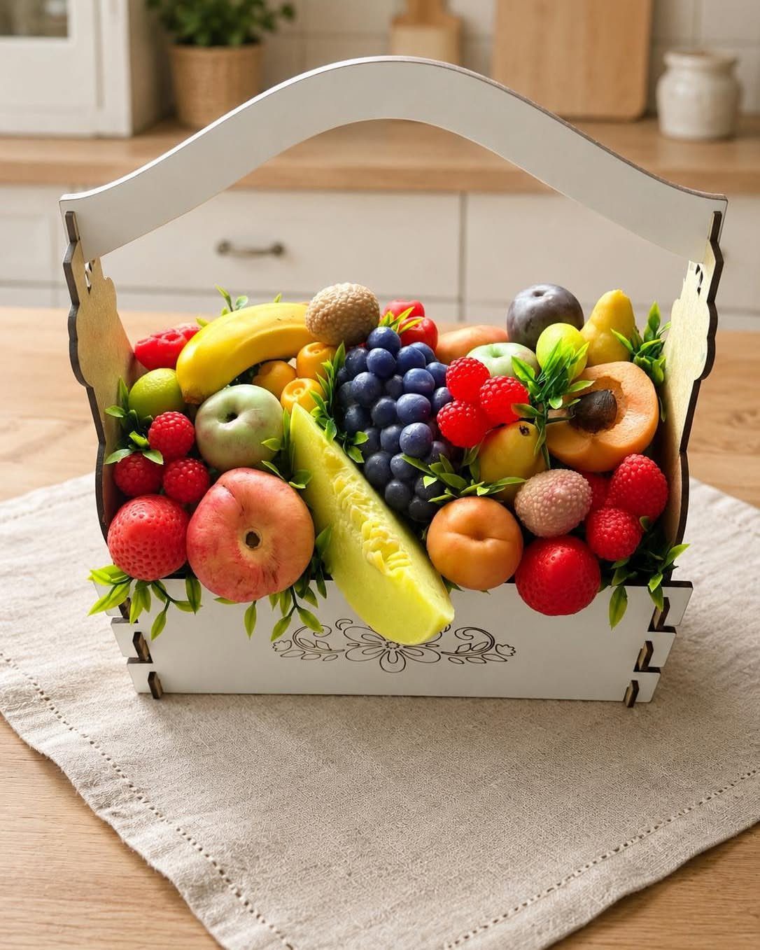 White wooden gift basket overflowing with colorful fresh fruits on a linen cloth.