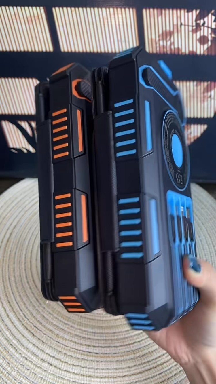 6 Last Minute Birthday Gifts for Dad He'll Actually Use 5 Two rugged phone cases in black with orange and blue accents held by hand.