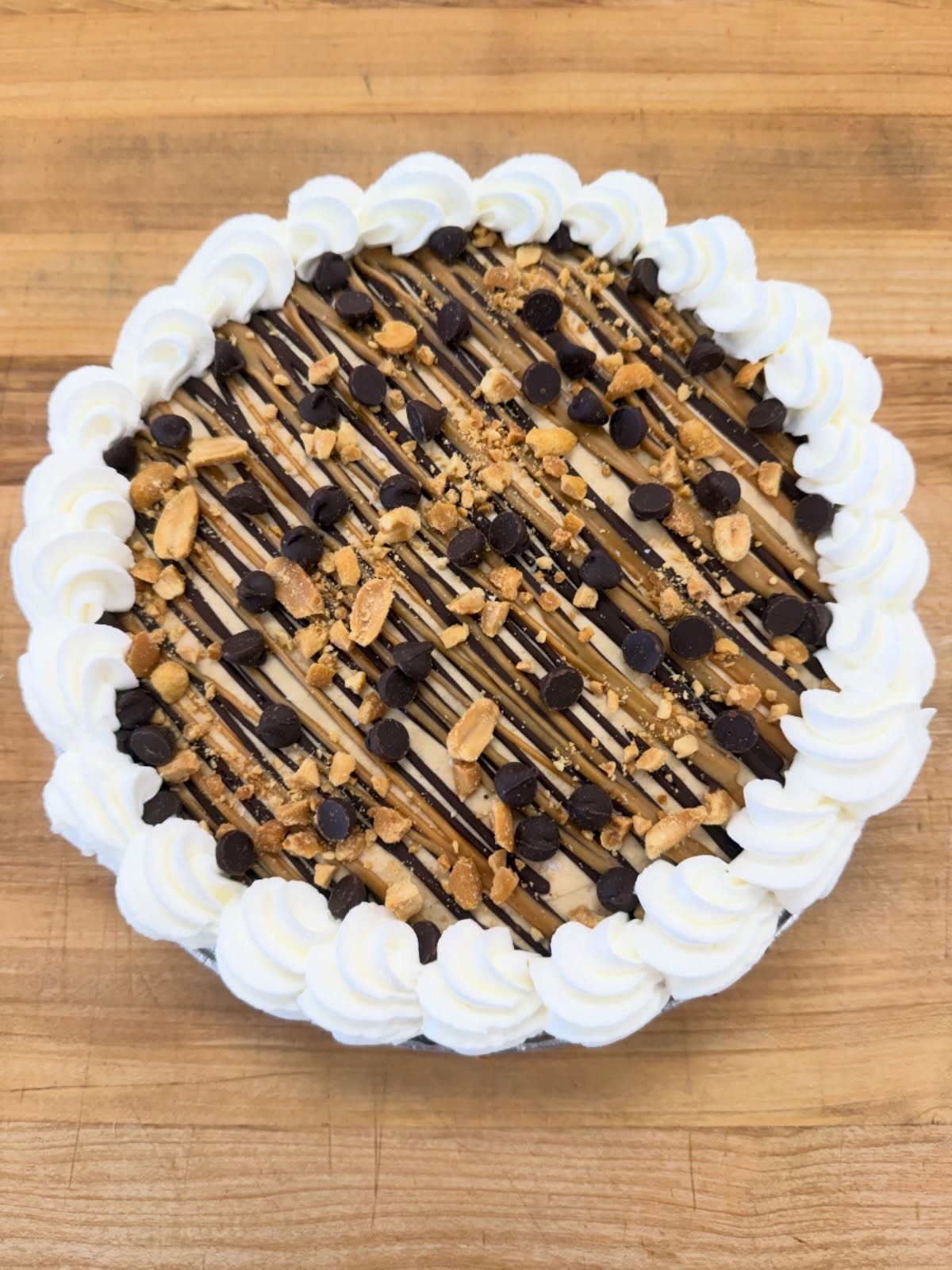 6 Last Minute Birthday Gifts for Dad He'll Actually Use 2 Round cake with chocolate drizzle, chocolate chips, and whipped cream on wooden table