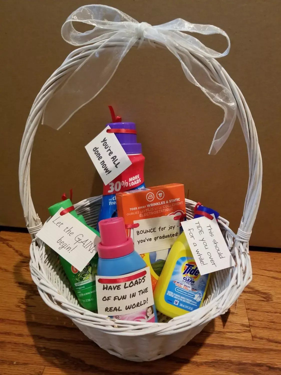 White wicker gift basket filled with laundry detergents and whimsical pun cards.