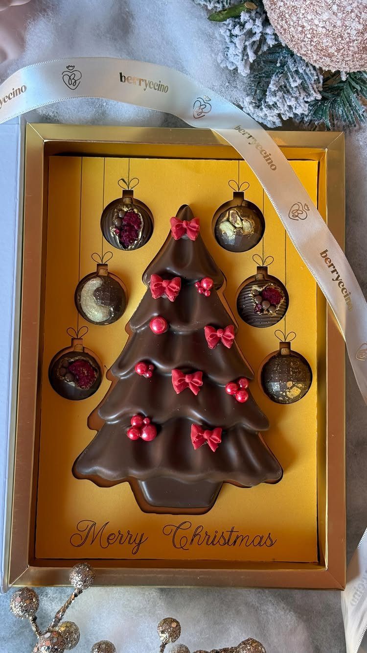 6 Meaningful Christmas Gifts for People You Love 4 Chocolate Christmas tree and ornaments in a gold gift box with festive decorations.