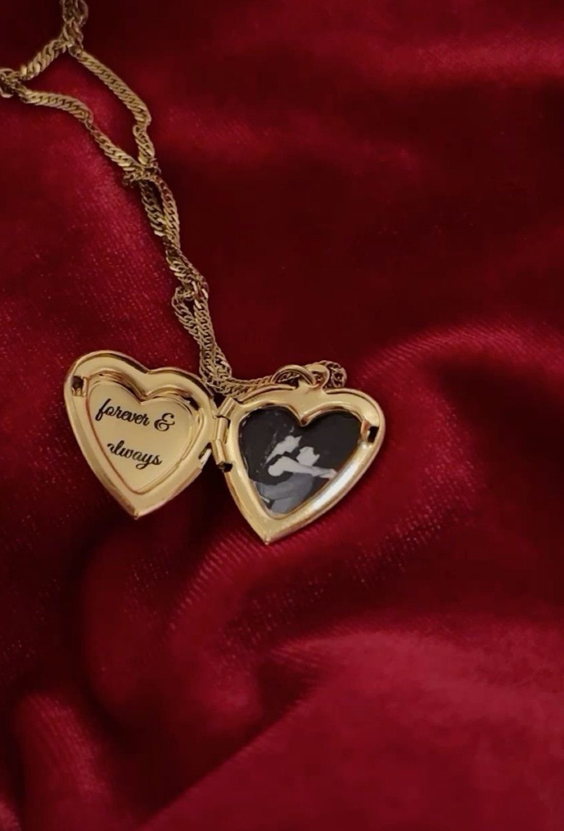 6 Meaningful Christmas Gifts for People You Love 5 Gold heart locket open to reveal a photo and engraved text on red velvet
