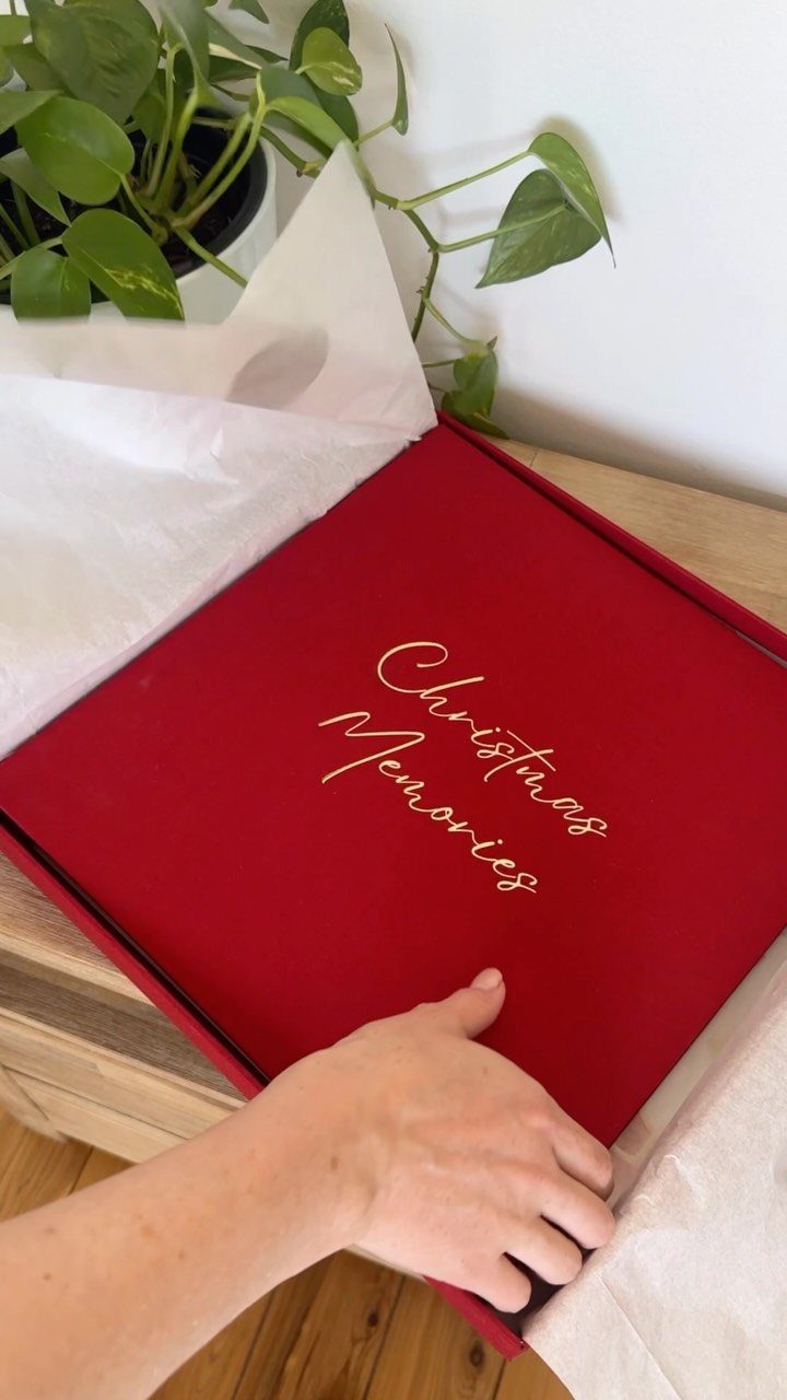 6 Meaningful Christmas Gifts for People You Love 6 Red fabric photo album with gold Christmas Memories text on a wooden table