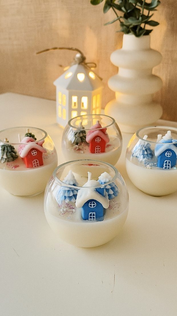 6 Meaningful Christmas Gifts for People You Love 1 Round glass candles with miniature wax houses and trees inside white wax.