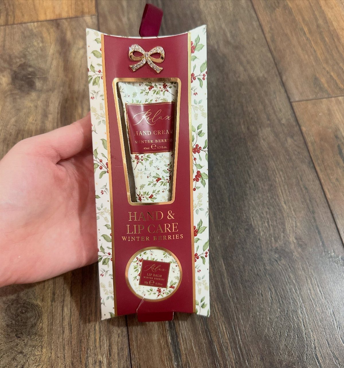 11 Mother in Law Birthday Gift Ideas She Will Actually Use 4 Gift boxed hand cream and lip care set in red winter berries packaging.