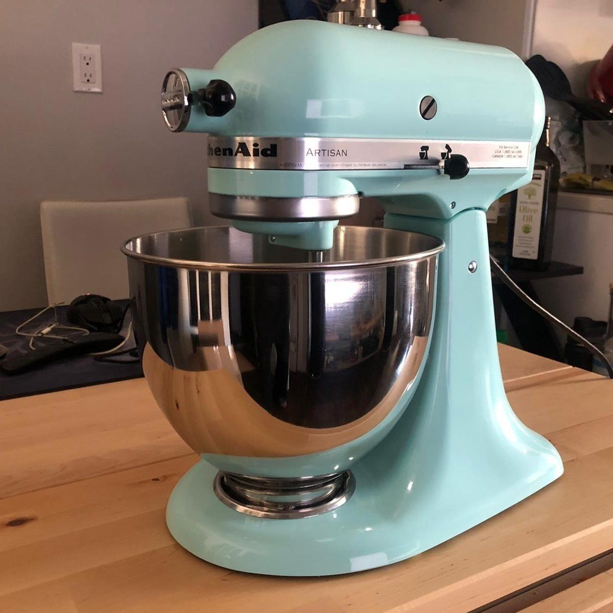11 Mother in Law Birthday Gift Ideas She Will Actually Use 2 Light blue KitchenAid Artisan stand mixer with stainless steel bowl on wooden counter
