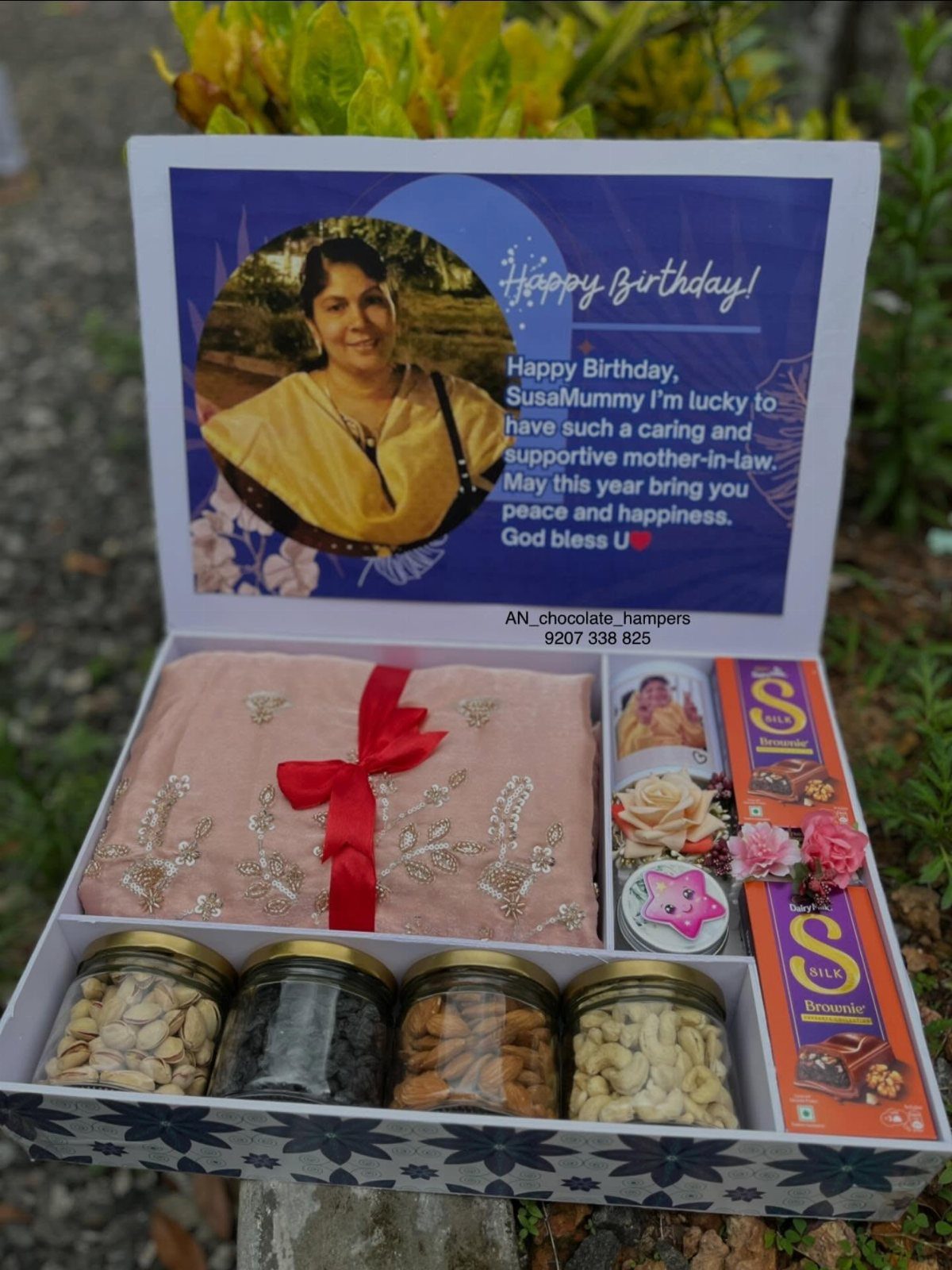 11 Mother in Law Birthday Gift Ideas She Will Actually Use 8 Gift hamper box with nuts, chocolates, pink fabric, and personalized birthday card.