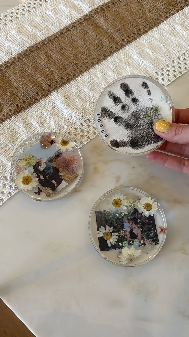 18 Mothers Day Gifts to Make: Easy Handmade Ideas for Mom 10 Three round resin coasters with a handprint, dried flowers, and a photograph.