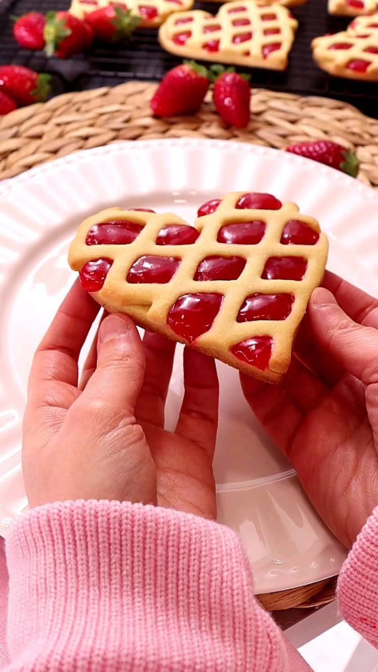 18 Mothers Day Gifts to Make: Easy Handmade Ideas for Mom 11 Heart-shaped lattice cookies with red jam filling held by hands in pink sweater