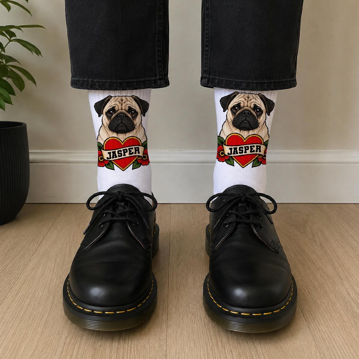White socks with a pug and name Jasper worn with black shoes.