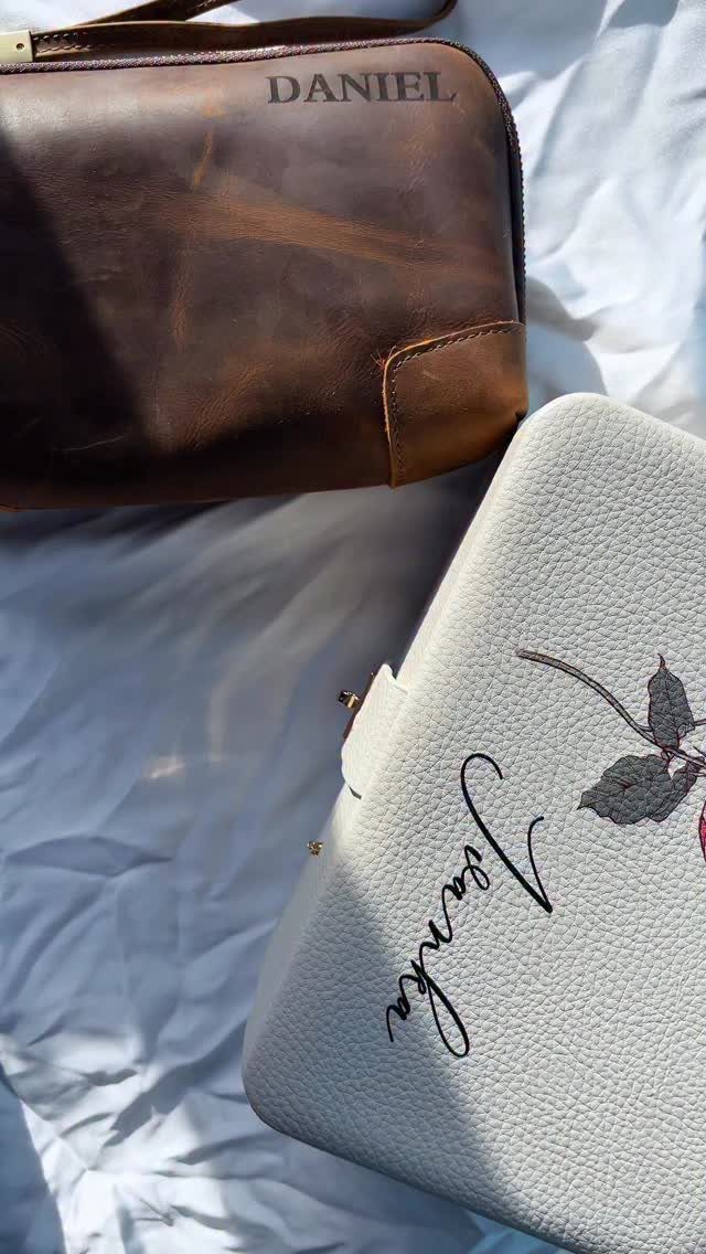 Brown leather bag embossed with Daniel and white case with Janka on white fabric