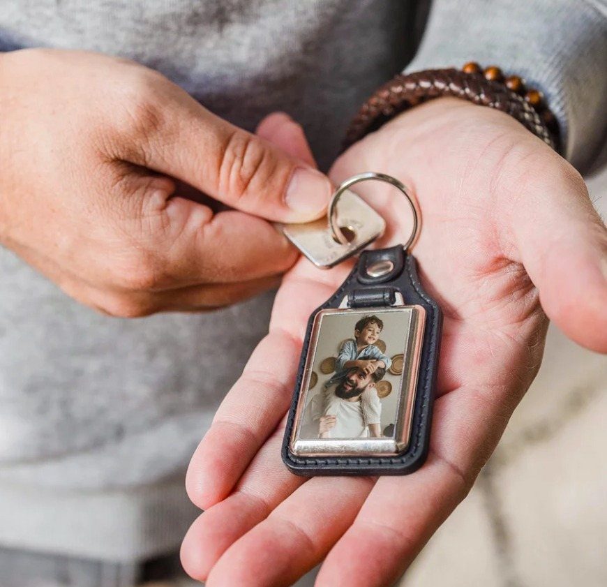 Leather keychain with a photo of a father and child held in hands
