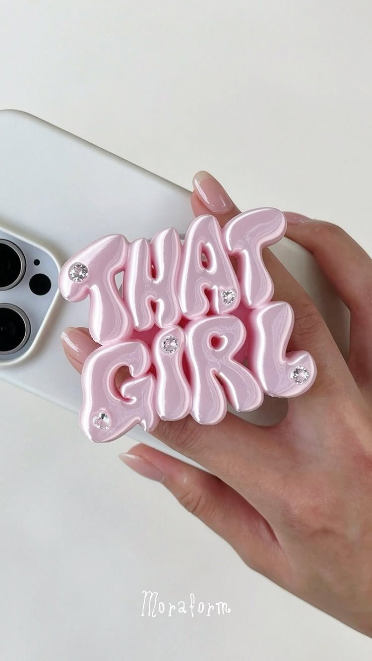 17 Personalized Gifts for Friends: Ideas for Every Budget 11 Pink bubble-letter phone grip saying THAT GIRL on a white smartphone.