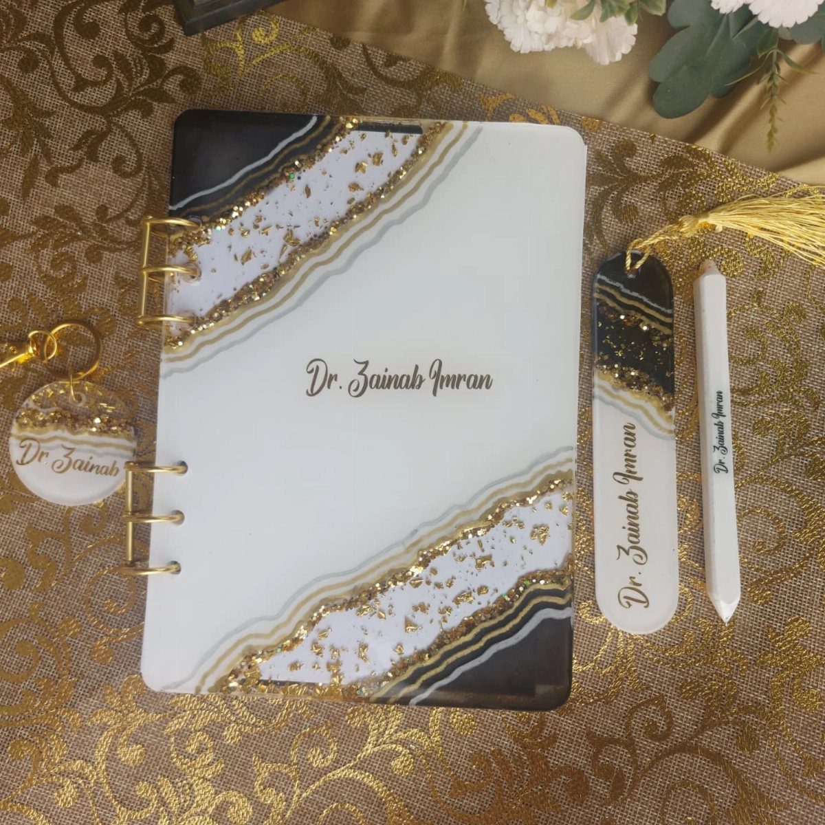 17 Personalized Gifts for Friends: Ideas for Every Budget 9 Personalized stationery set with notebook, pen, and keychain featuring gold marble accents.