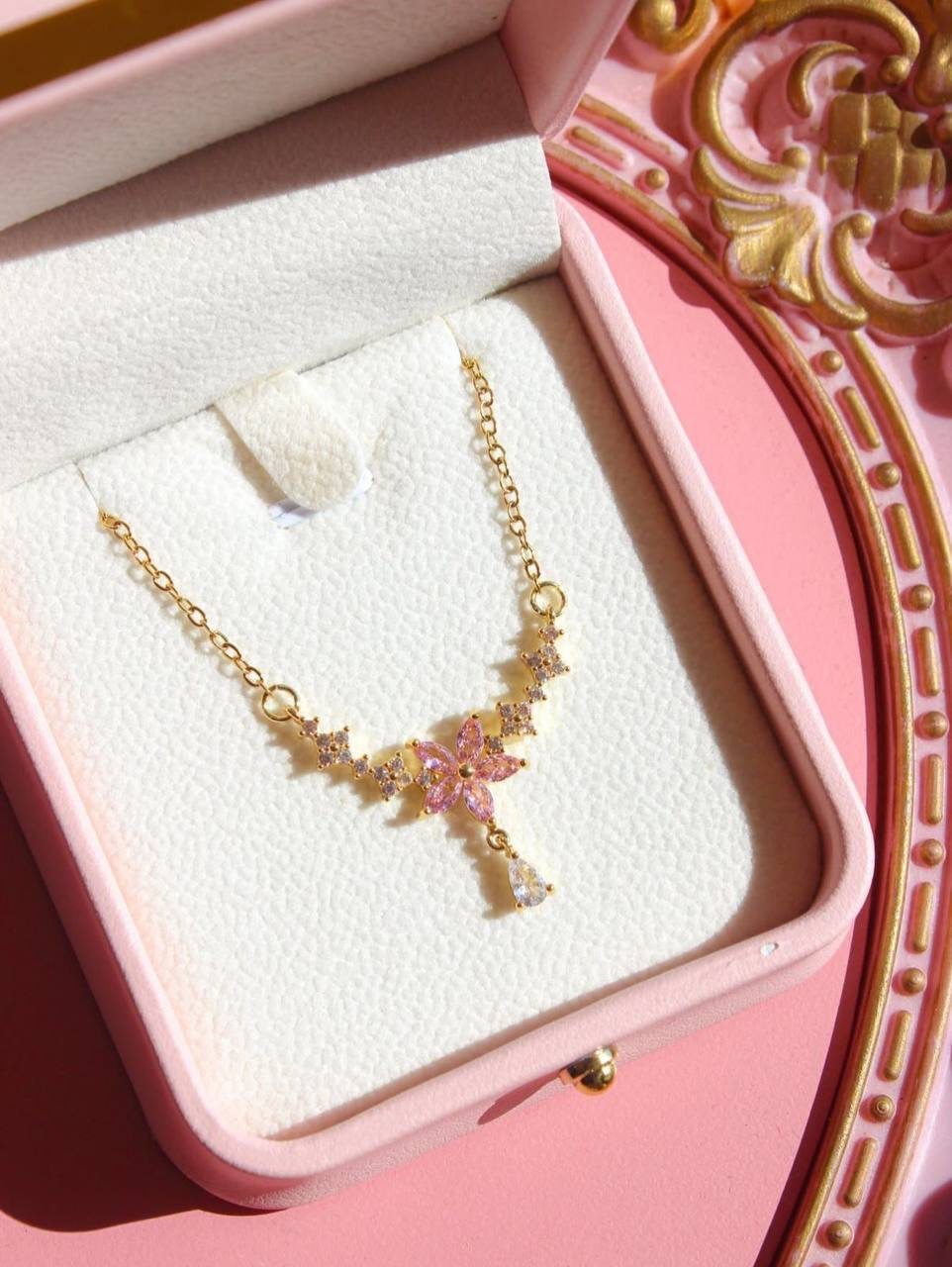 24 Pink Christmas Gift Ideas from Cozy to Glam 14 Gold necklace with pink flower crystals in a pink jewelry box