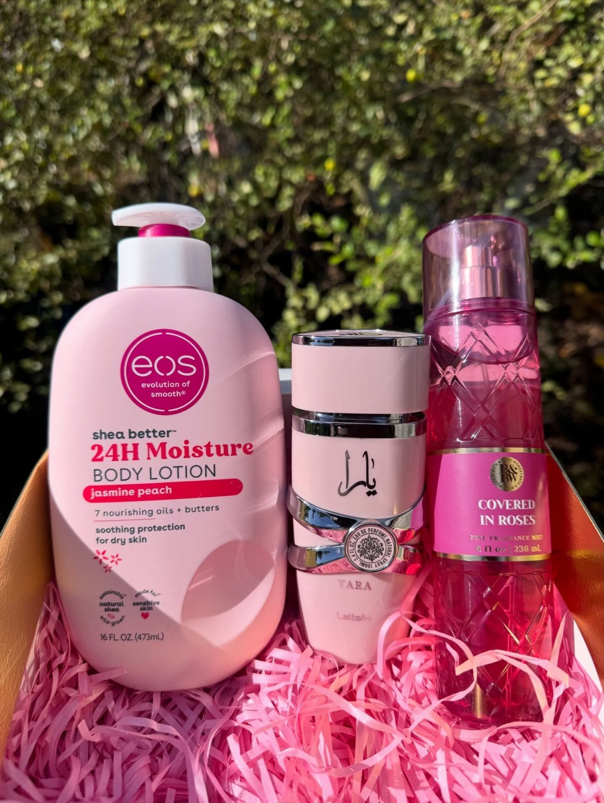 24 Pink Christmas Gift Ideas from Cozy to Glam 2 Pink body lotion, perfume, and fragrance spray in a pink shredded paper gift box.