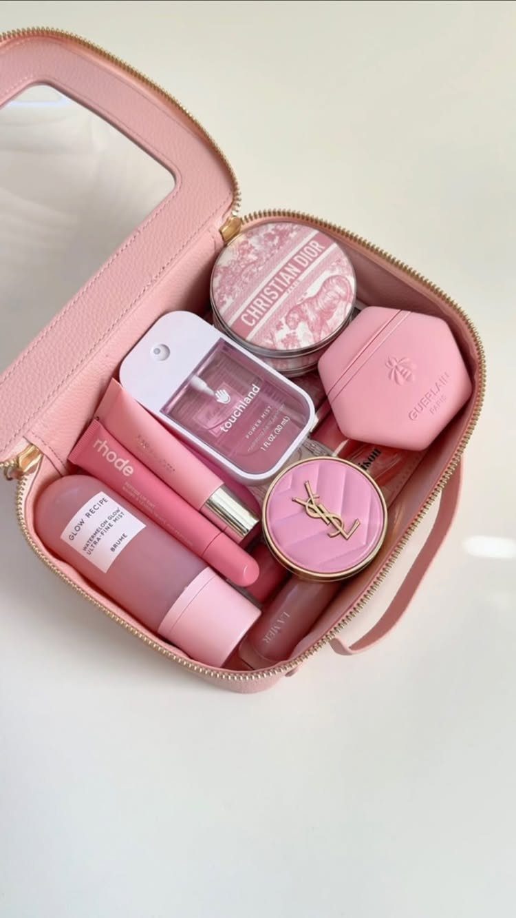 24 Pink Christmas Gift Ideas from Cozy to Glam 12 Pink makeup bag filled with various pink luxury beauty and skincare products.