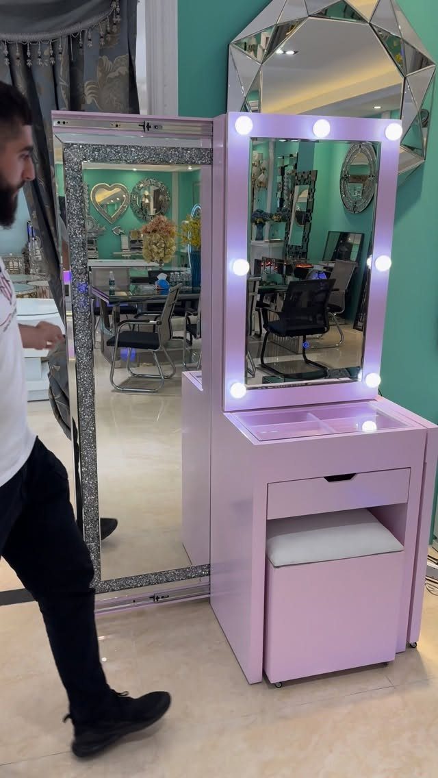 24 Pink Christmas Gift Ideas from Cozy to Glam 1 Pink vanity makeup station with a lighted mirror and matching small stool.