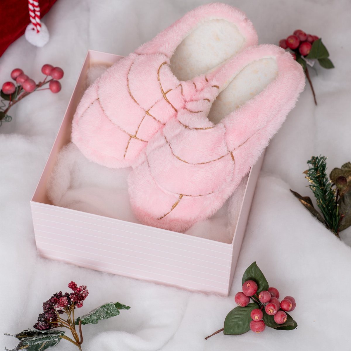 24 Pink Christmas Gift Ideas from Cozy to Glam 6 Pink fluffy slipper boots with gold accents in a pink gift box.