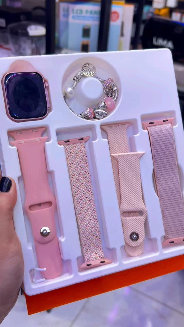 24 Pink Christmas Gift Ideas from Cozy to Glam 10 Pink smartwatch gift set with multiple pink bands and a pearl bracelet