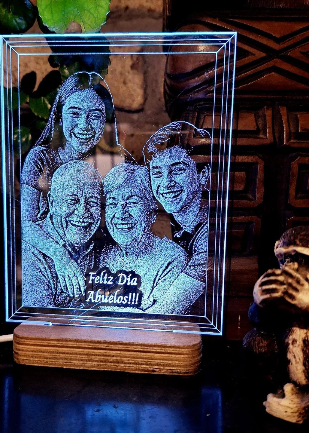 8 Senior Citizen Gift Basket Ideas for Grandparents 8 Etched glass lamp with a glowing blue family portrait on a wooden base