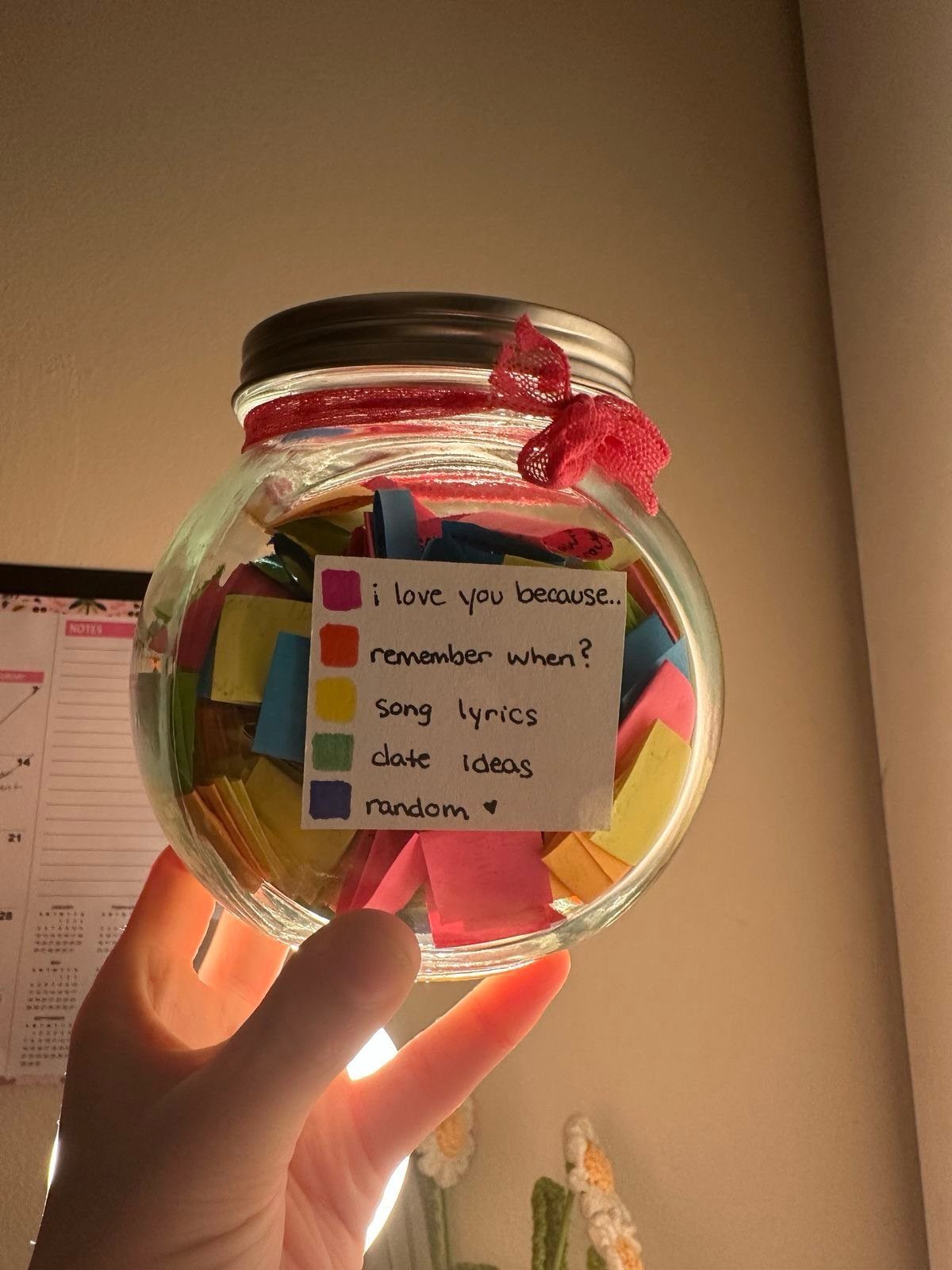 Glass mason jar filled with colorful notes and a sentimental category label.