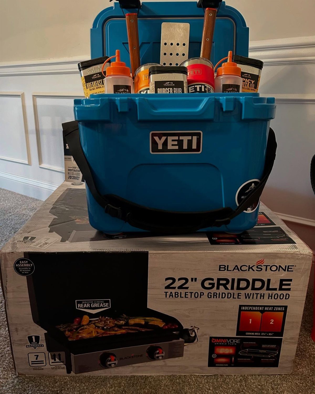 12 Silent Auction Gift Basket Ideas for Any Fundraiser 7 Blue Yeti cooler filled with grilling supplies sitting on a Blackstone griddle box.