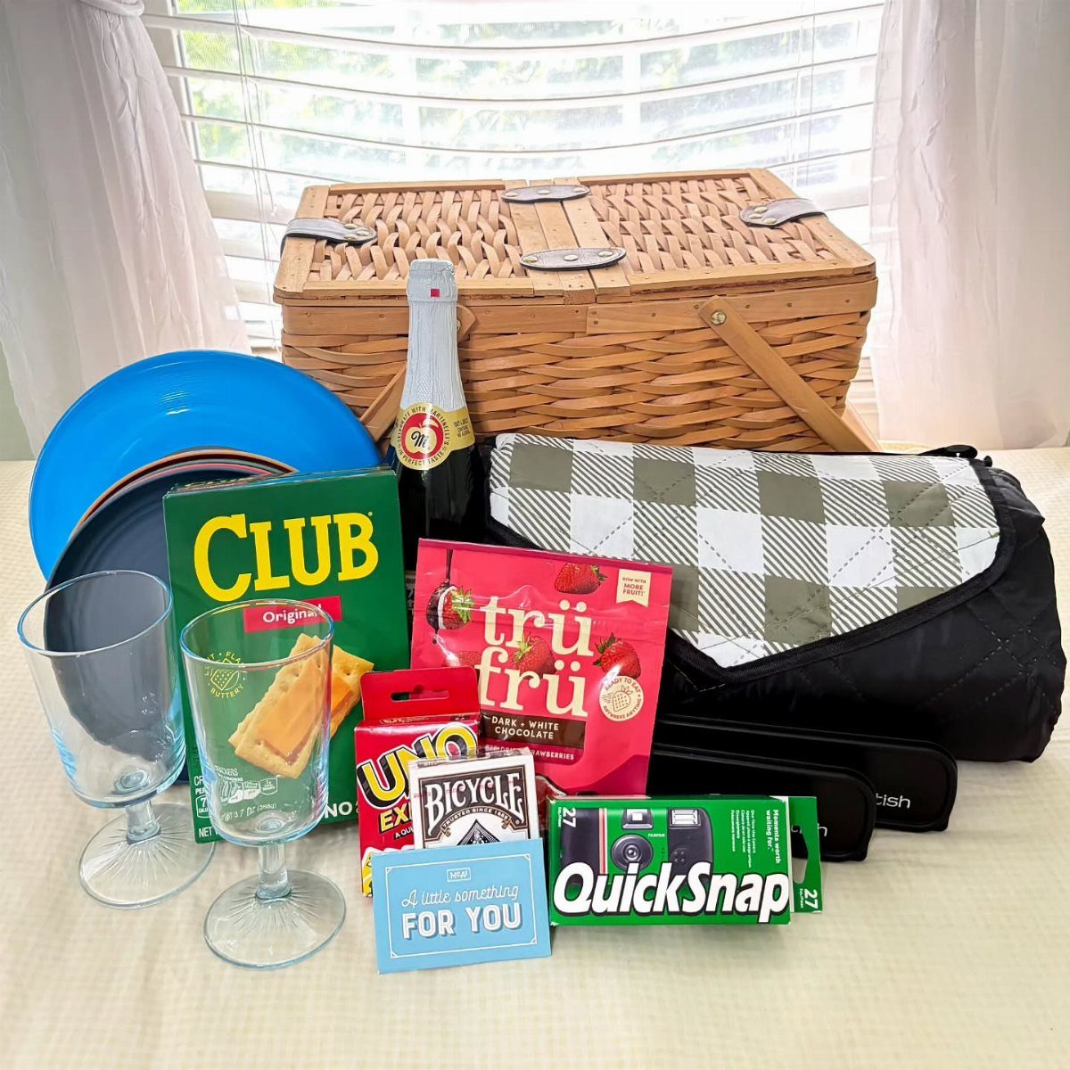 12 Silent Auction Gift Basket Ideas for Any Fundraiser 6 Picnic gift basket with sparkling wine, glasses, snacks, and a QuickSnap camera.