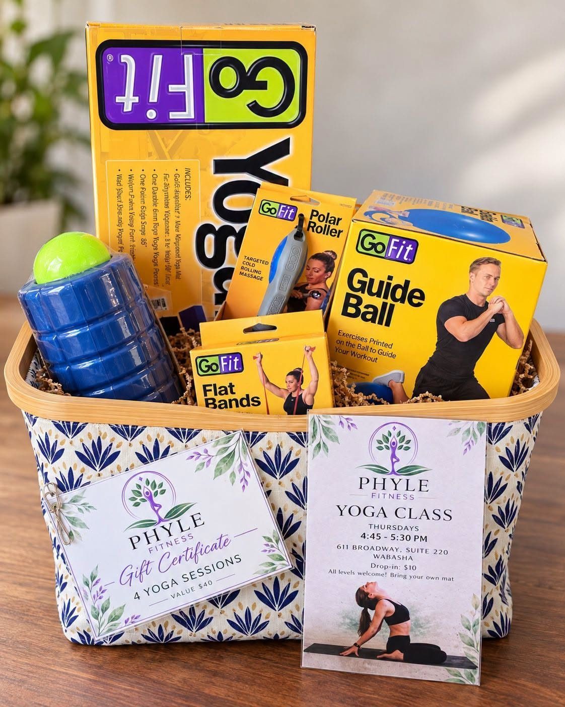 12 Silent Auction Gift Basket Ideas for Any Fundraiser 11 Fitness gift basket containing a yoga mat, foam roller, exercise bands, and yoga certificates.