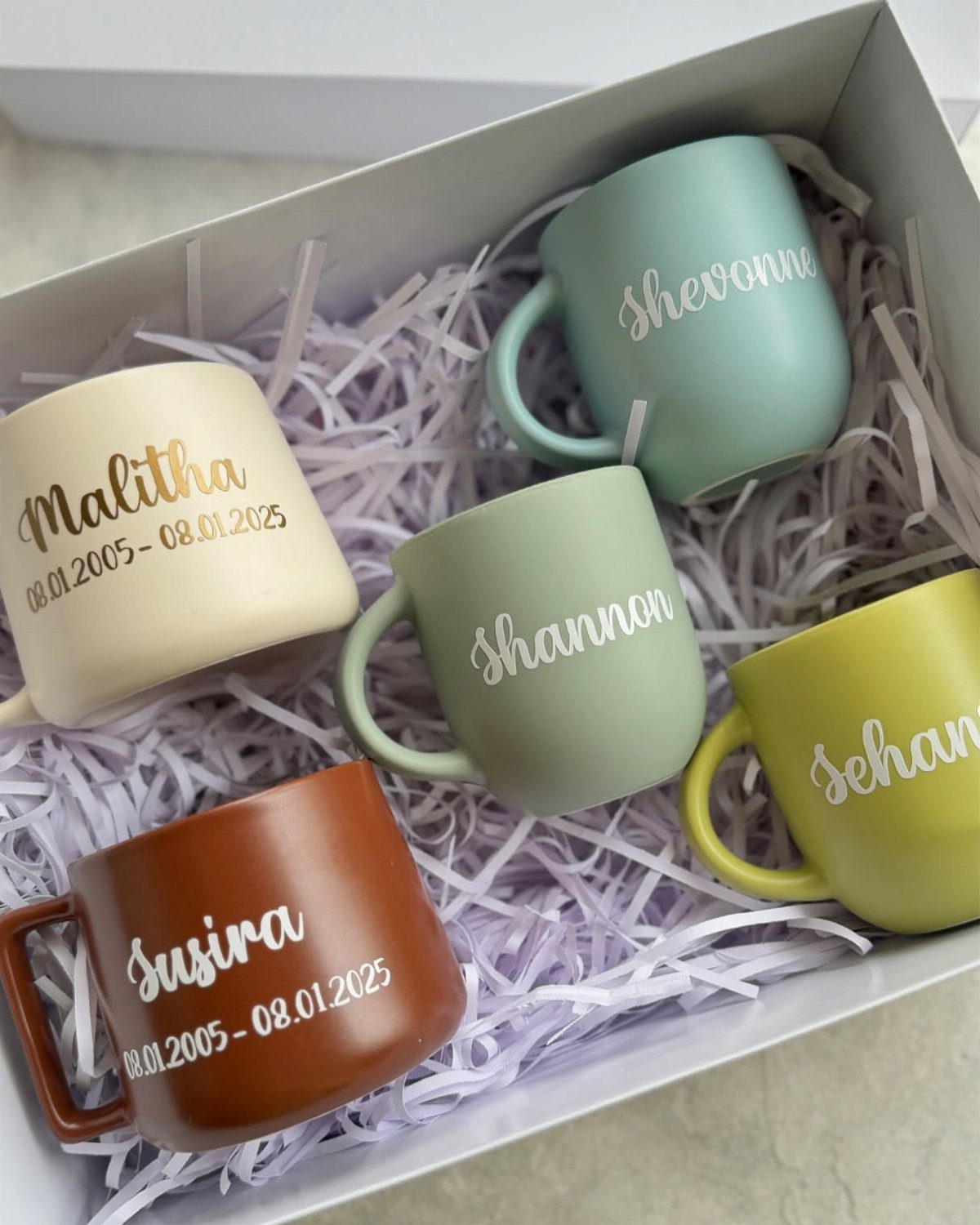 8 Small Gifts for Family That Everyone Will Enjoy 8 Personalized matte ceramic mugs with names in a white gift box with shredding