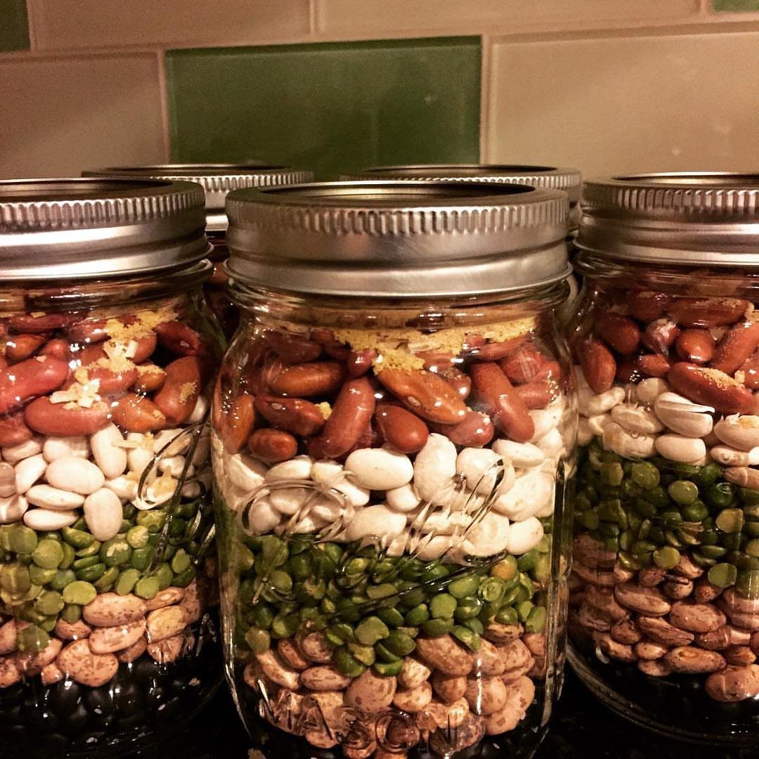 Layered dried beans and lentils in glass mason jars for soup kits.