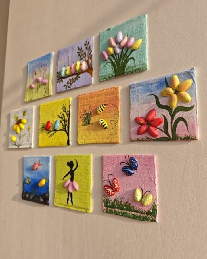 Small painted canvases with 3D candy art depicting nature scenes on a wall