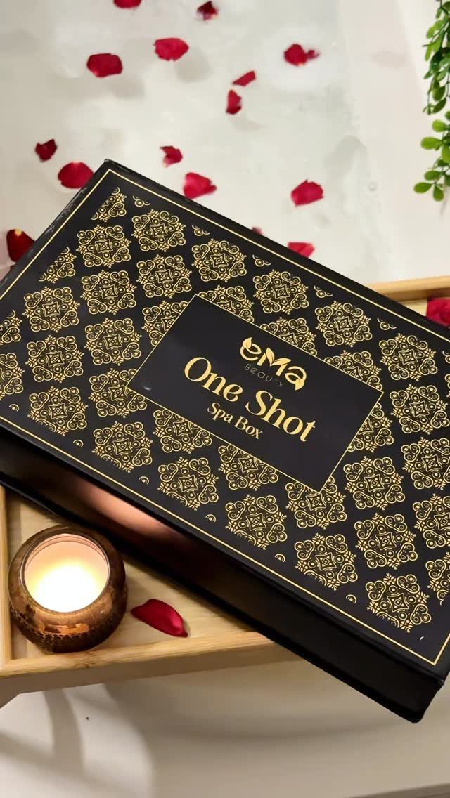 11 Spa Day Gift Basket Ideas for Relaxing at Home 7 Black and gold spa gift box on a tray with a lit candle.