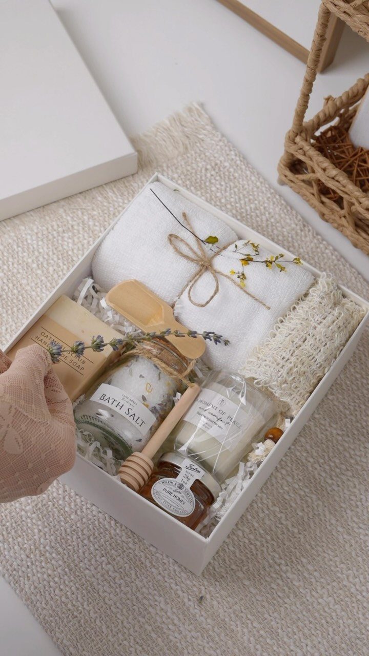11 Spa Day Gift Basket Ideas for Relaxing at Home 2 Spa gift box with rolled towels, bath salts, candle, honey, and handmade soap.