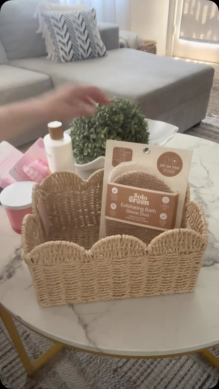 11 Spa Day Gift Basket Ideas for Relaxing at Home 11 Woven beige gift basket with bath products and exfoliating gloves on marble table