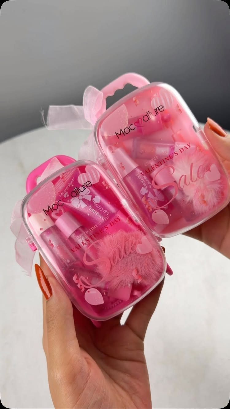 11 Spa Day Gift Basket Ideas for Relaxing at Home 8 Two pink cosmetic pouches filled with beauty products and heart decorations held by hands.