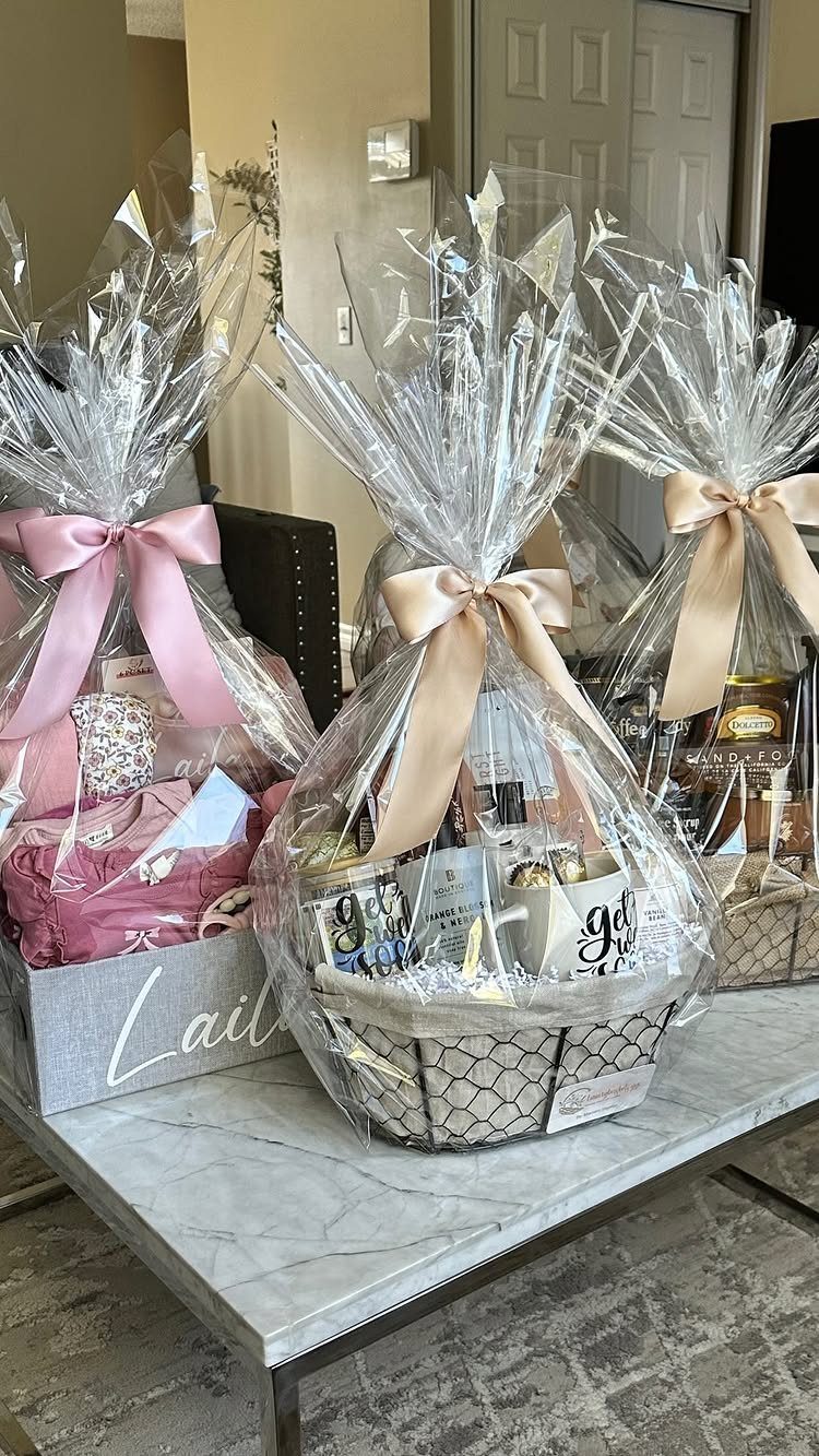 Spa Gift Basket Ideas: 8 Picks for Relaxing at Home 3 Three cellophane-wrapped spa gift baskets with ribbons on a white marble table.
