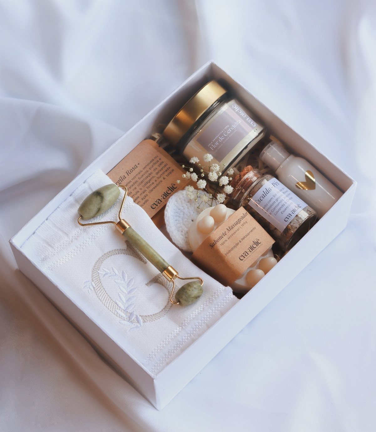 Spa Gift Basket Ideas: 8 Picks for Relaxing at Home 7 Spa gift box with jade roller, skincare products, and a white towel.