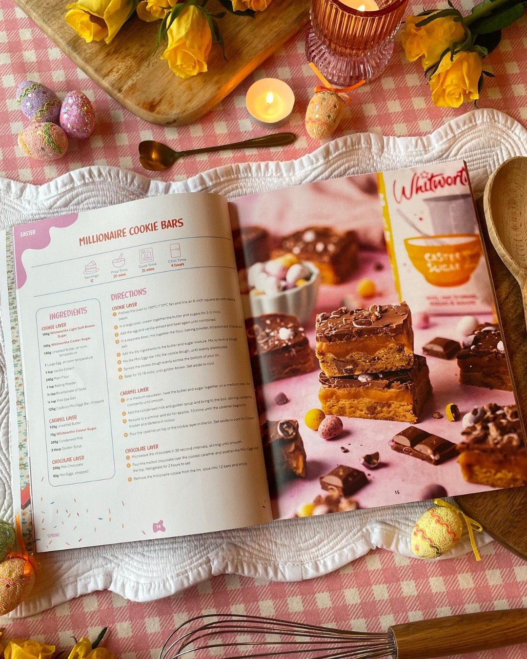 Open cookbook with cookie bar recipe surrounded by yellow roses and spring decor.