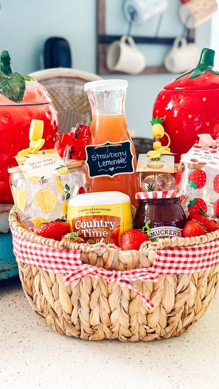 Woven gift basket filled with strawberry themed treats, lemonade, and fresh berries.