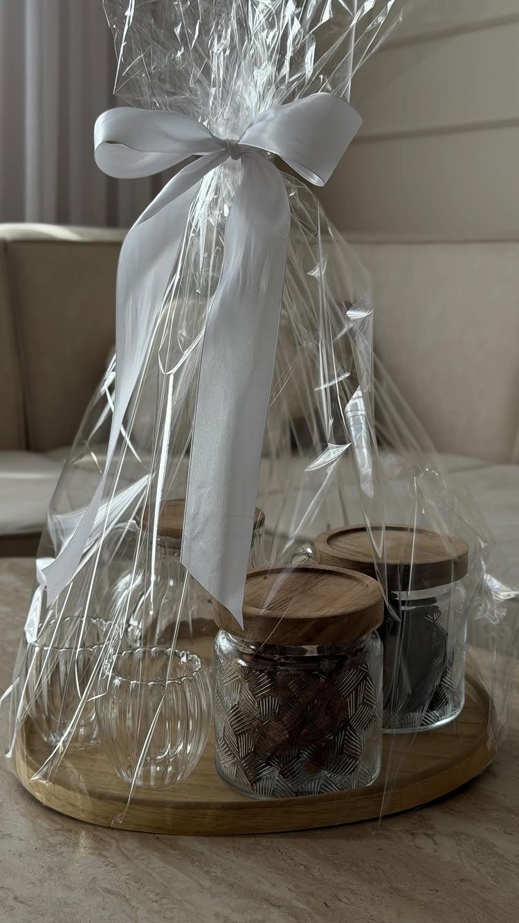 Tea gift set with glass jars and a cup wrapped in cellophane.