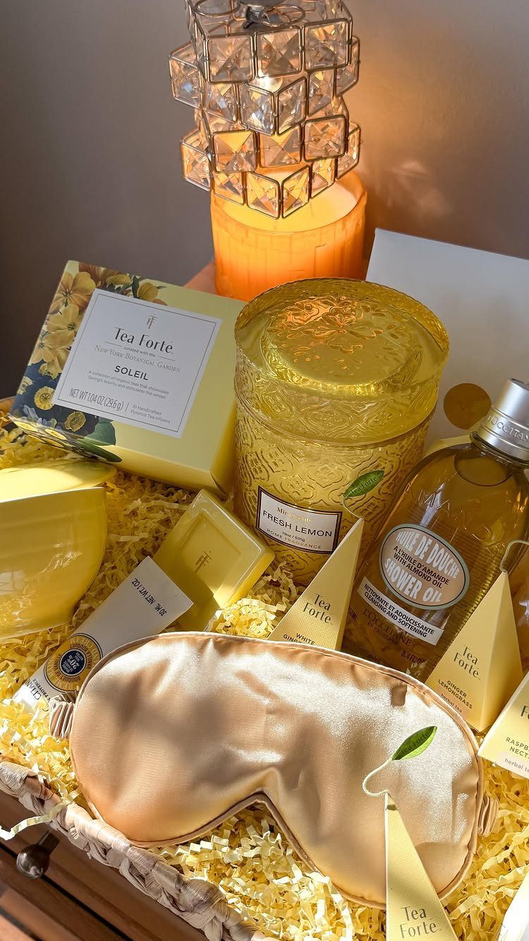 Tea gift basket with gold tea canister, sleep mask, and tea boxes.