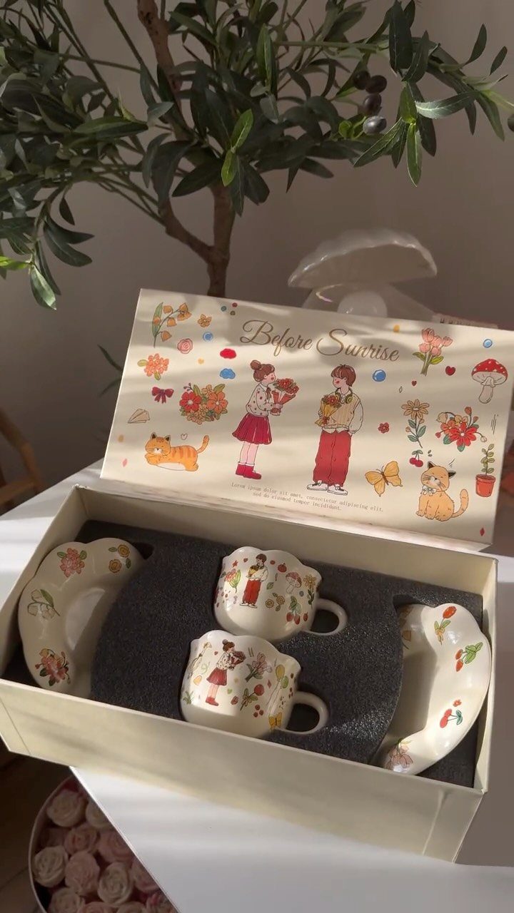 Tea cup and saucer gift set in a decorated white box with illustrations.