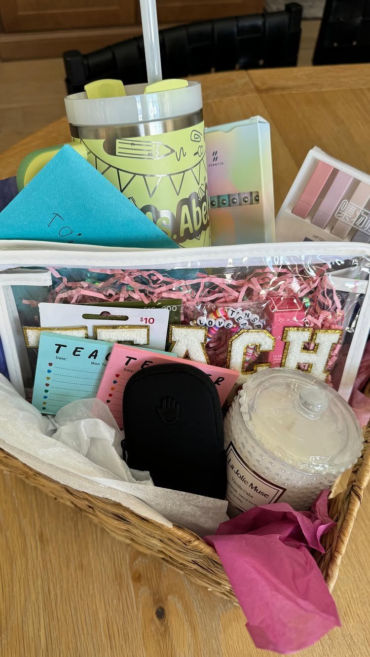 8 Teacher Gifts They Actually Want, From Notes to Totes 4 Wicker gift basket filled with a tumbler, candle, and teacher-themed stationery items.