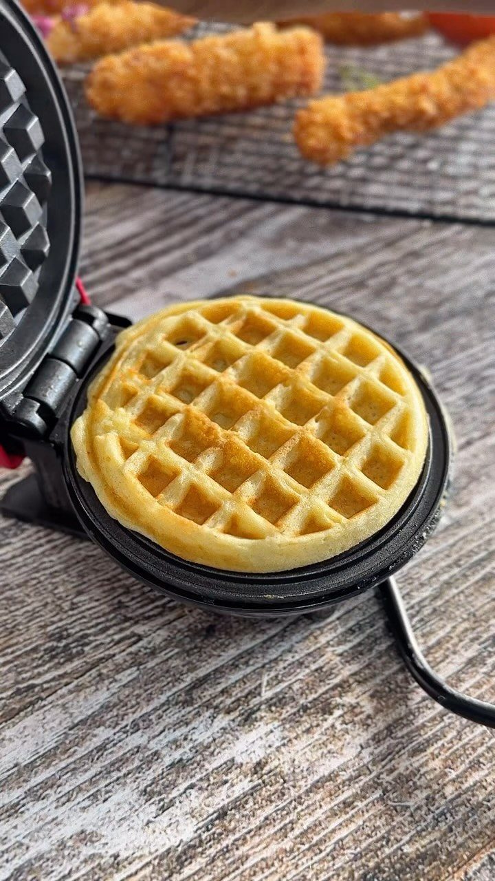 7 Thanksgiving Teacher Gifts for a Heartfelt Thank-You 6 Mini waffle maker with a golden-brown waffle on a rustic wooden table